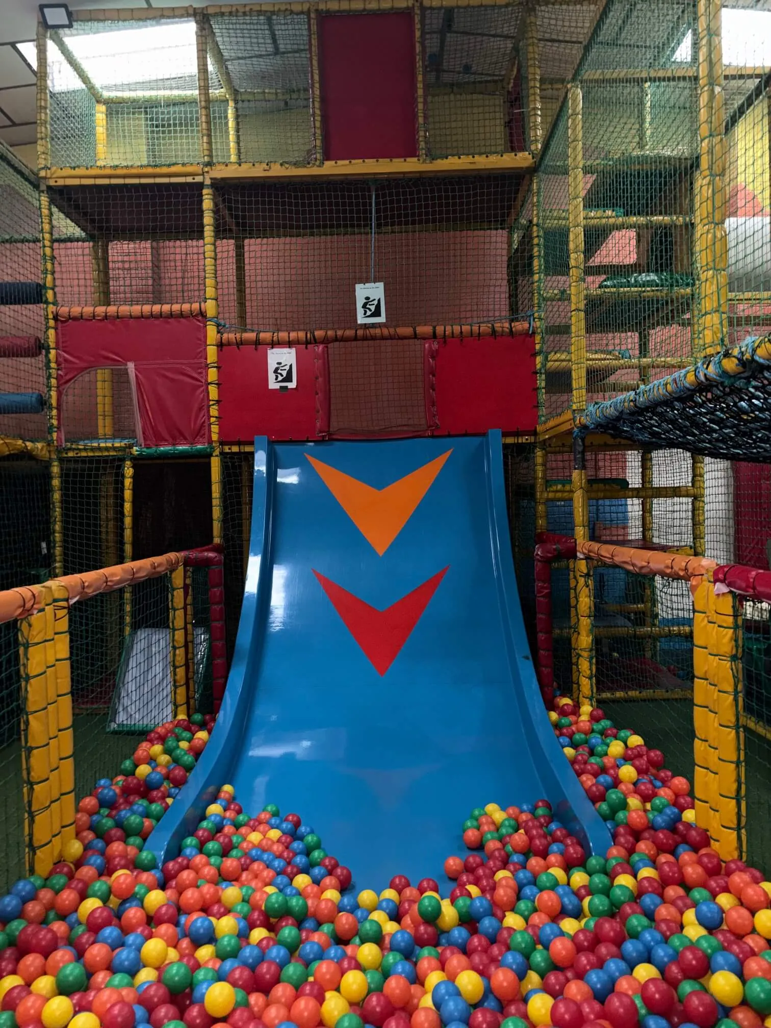 Child sliding down the indoor soft play slide at Zone Play Cardiff